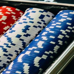 Stacks of red, white, and blue poker chips arranged in a tray/holder.