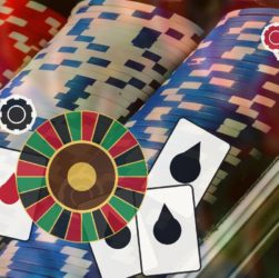 Casino scene featuring a colorful roulette wheel, stacked poker chips, and playing cards on a blurred background.